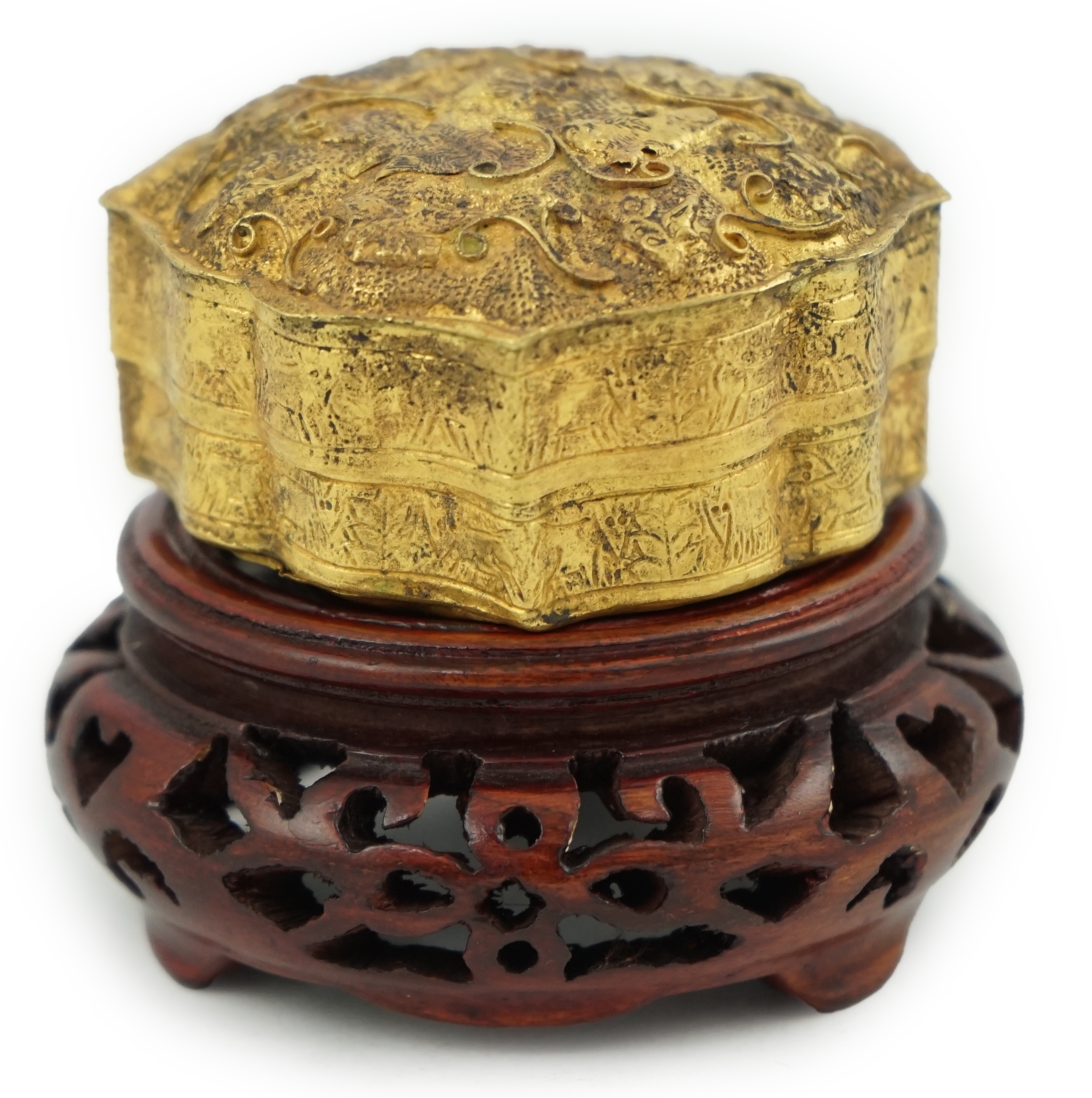 'An 18th century Chinese gilt repousee box & cover, probable Liao Dynasty', of petal lobed form, decorated with lions amid filigree scroll work, 5.5cm across